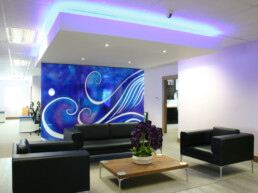 Office interior reception waiting area with downstand ceiling and bespoke glass artwork panels