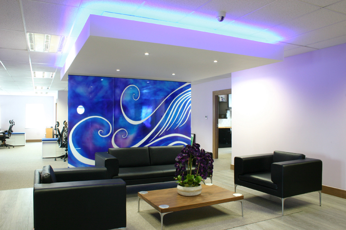 Office interior reception waiting area with downstand ceiling and bespoke glass artwork panels